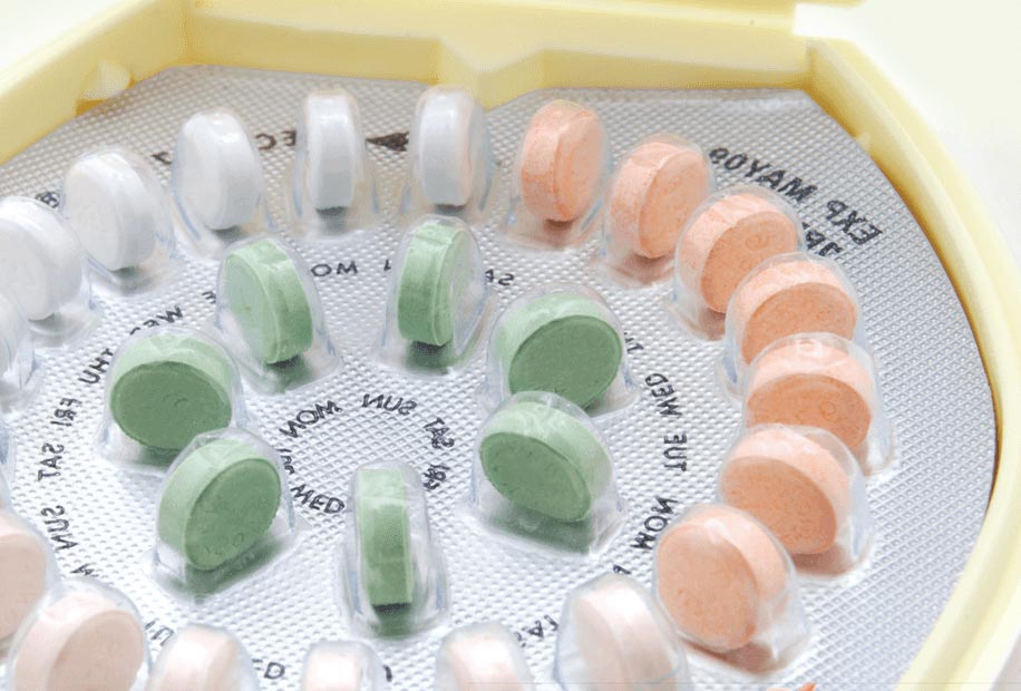 close up on a woman's birth control pill kit